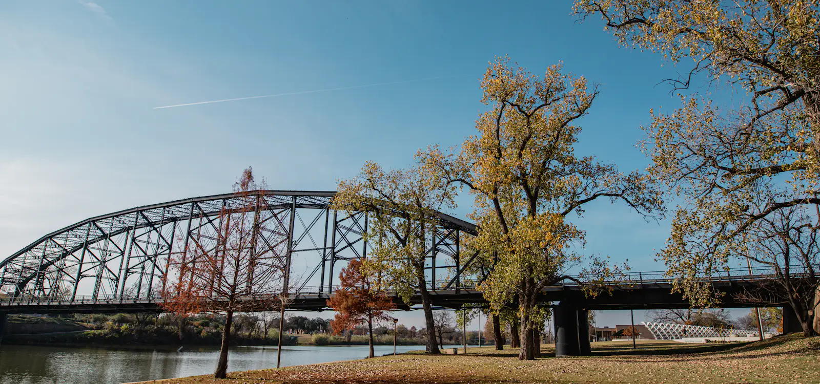 The Waco Suspension Bridge over the Brazos River on a clear autumn day